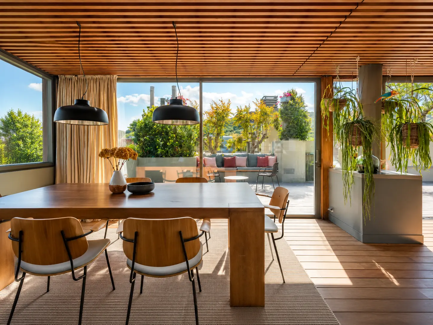 Dining room with wooden table and slatted timber ceiling