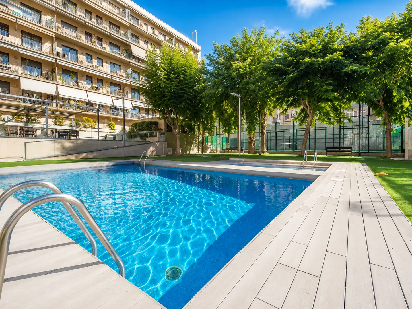 Communal pool, gardens and padel court of the residence
