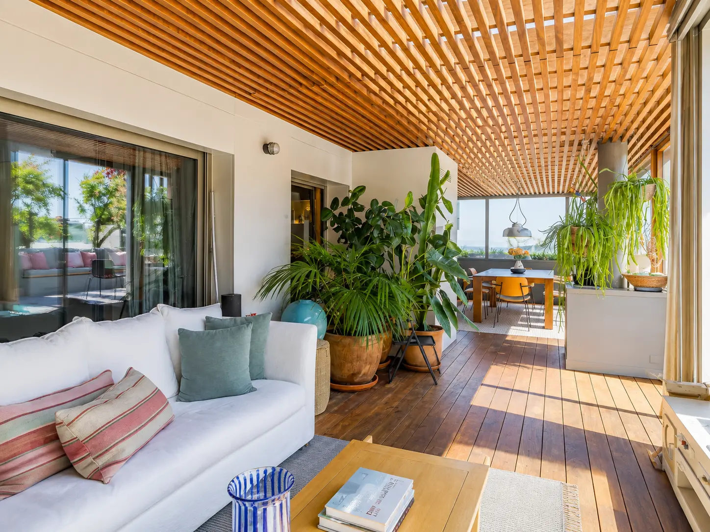 Covered porch with plants linking living and dining rooms